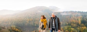 Una pareja mayor con un paisaje de montaña a sus espaldas