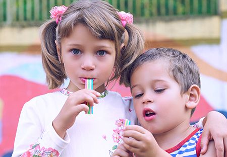 niña y niño comiendo chicle