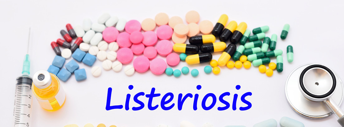 Diferentes medicamentos en pastillas y cápsulas, jeringuilla y la palabra listeriosis escrita