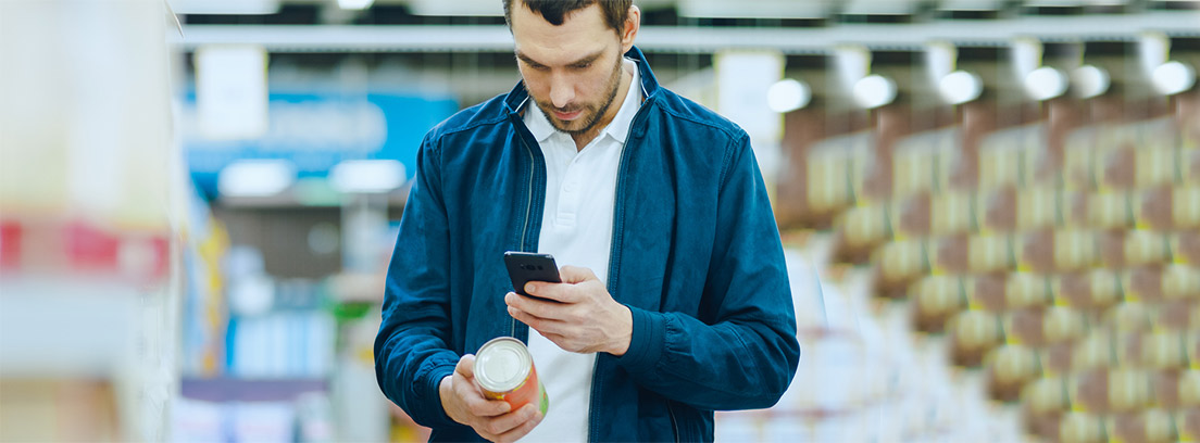 hombre joven comprobando mediante una app del móvil un alimento