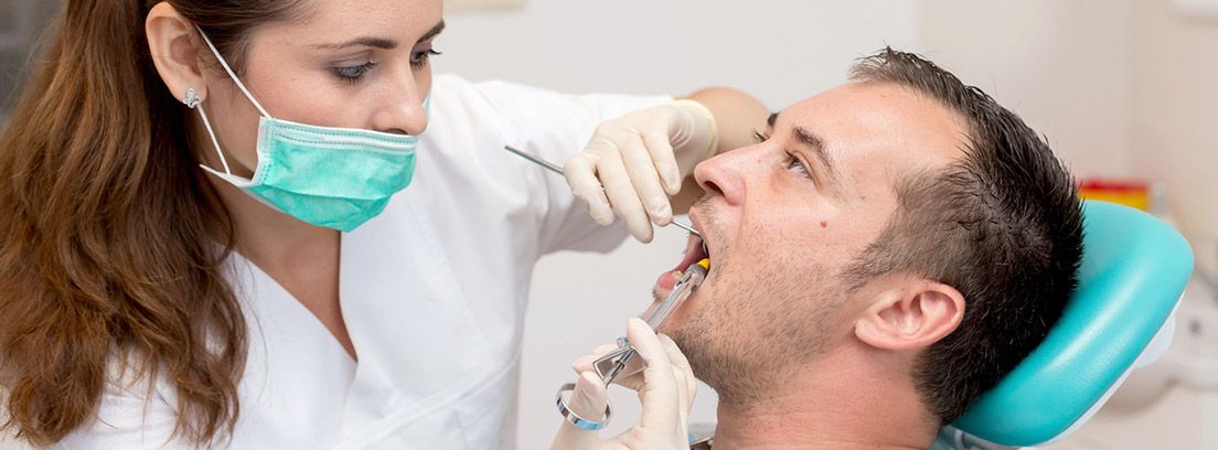 Tipos de anestesia bucodental: dentista poniendo anestesia bucal a paciente