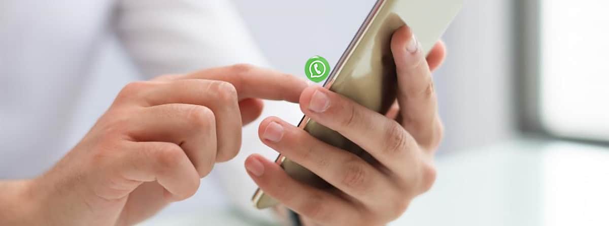 Primer plano de unas manos utilizando el WhatsApp del móvil