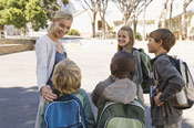 mujer con niños con mochilas a la espalda Salud niño-monográficos-infantiles-vuelta al cole