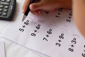 Niño con hoja de problemas matemáticos